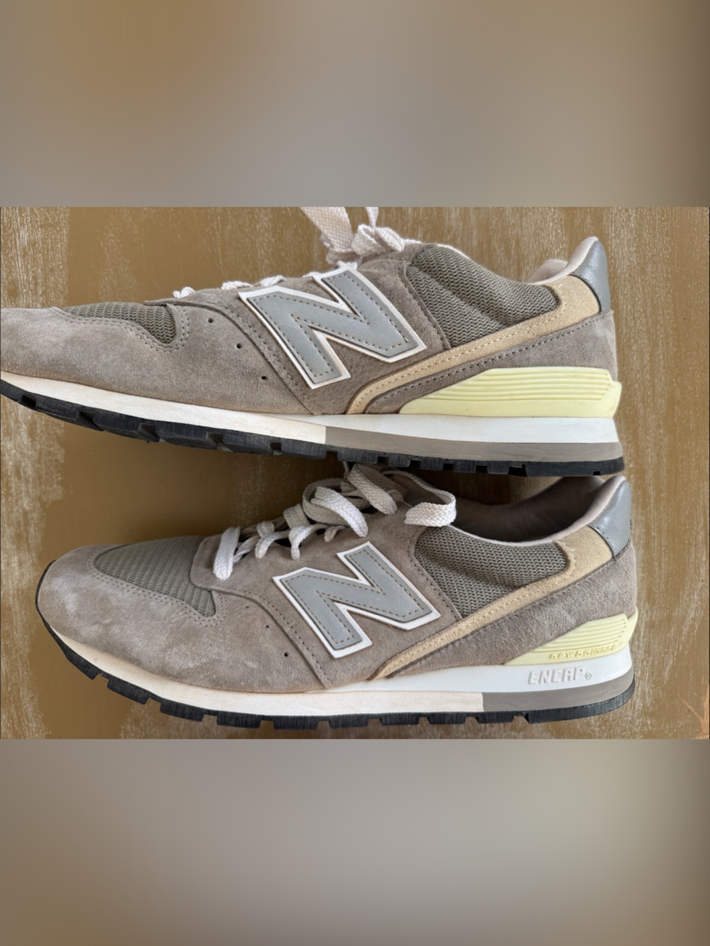 New Balance taupe suede sneakers with cream and pale yellow accents